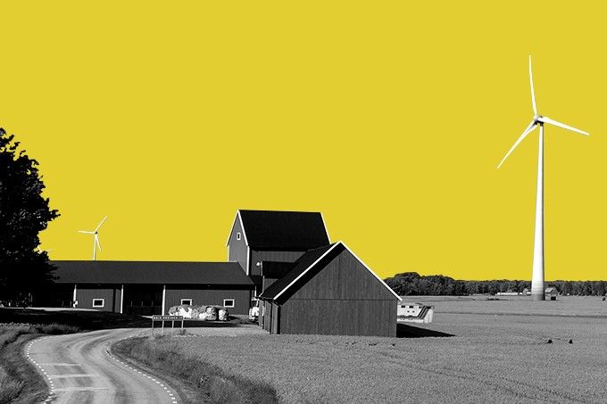 Wind turbines and a farmhouse.