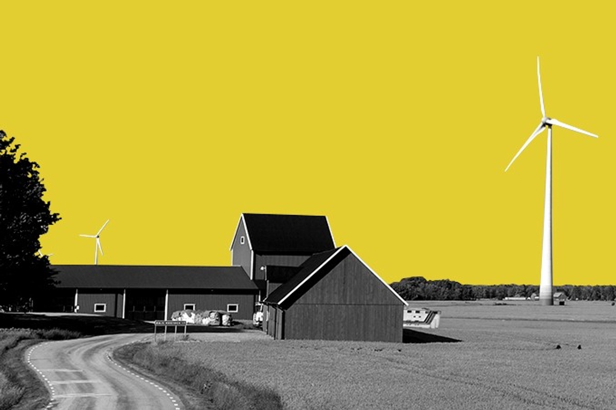 Wind turbines and a farmhouse.