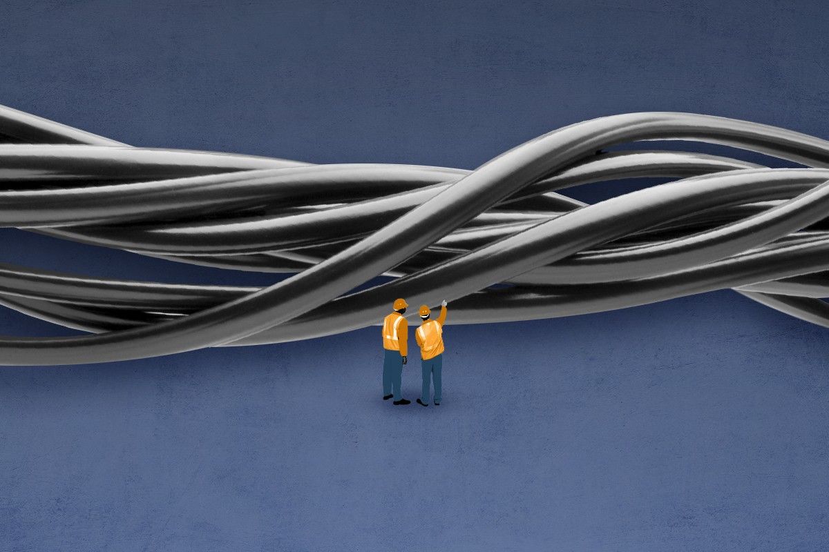 Workers looking at wires.