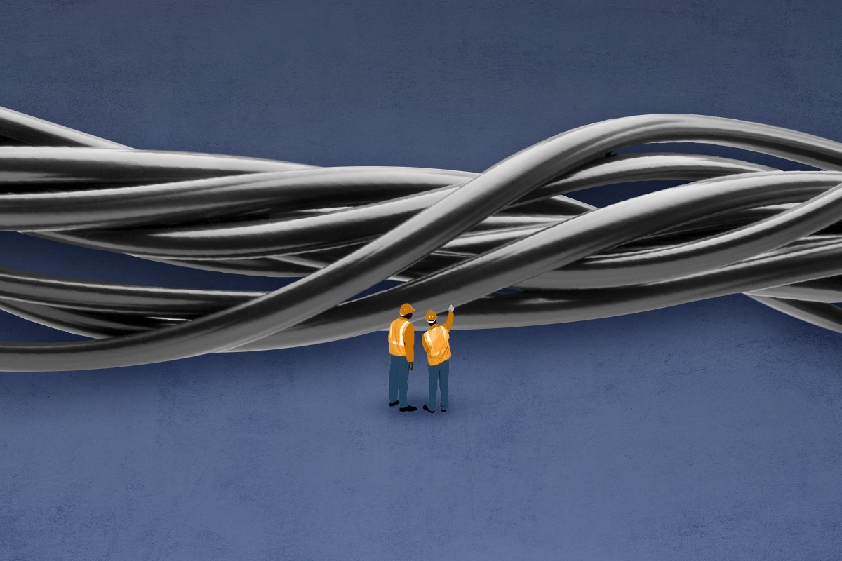 Workers looking at wires.