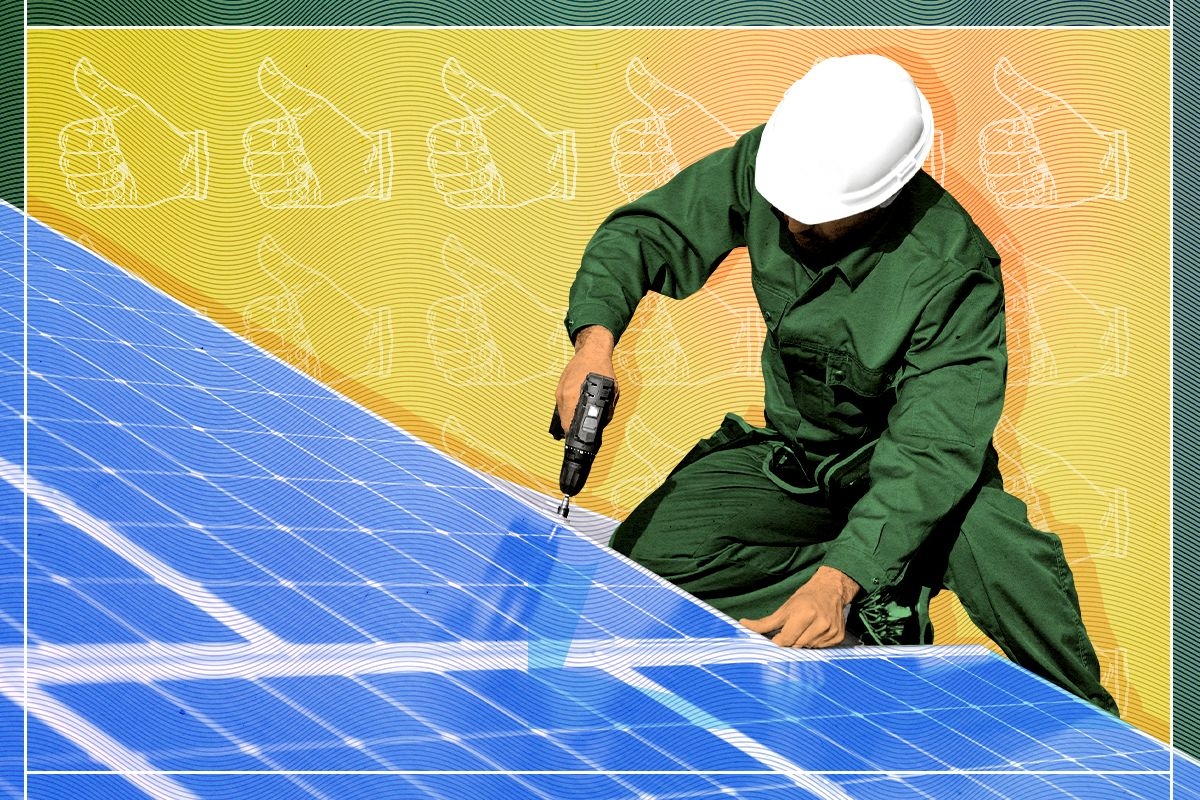 A worker installing solar panels.