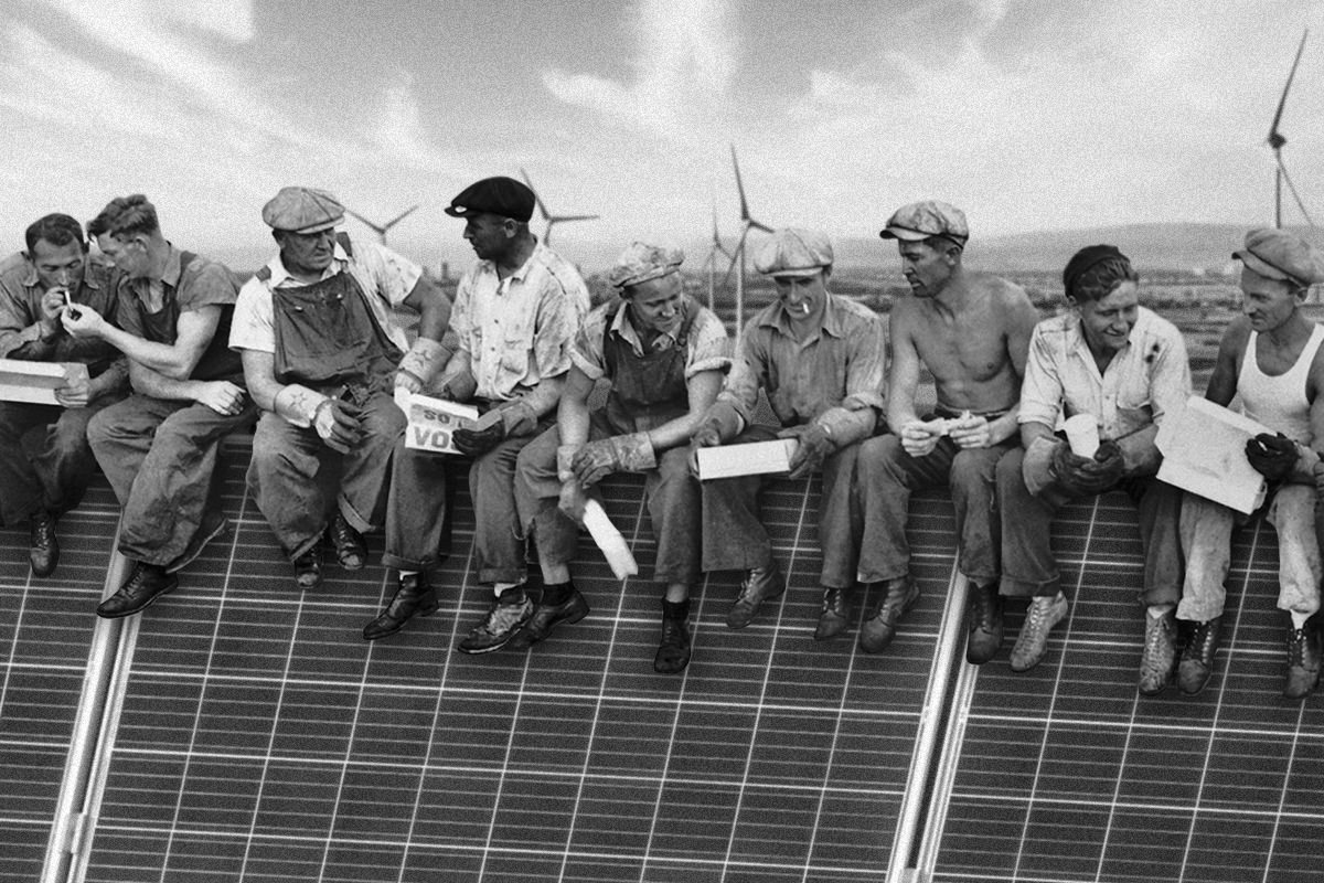 Workers sitting on solar panels.