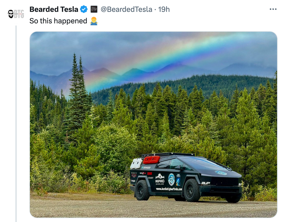 Cybertruck in the woods with a rainbow