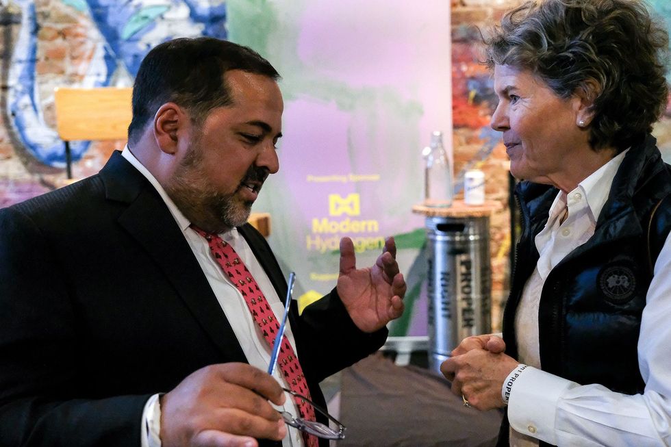 Neil Chatterjee and an event guest.