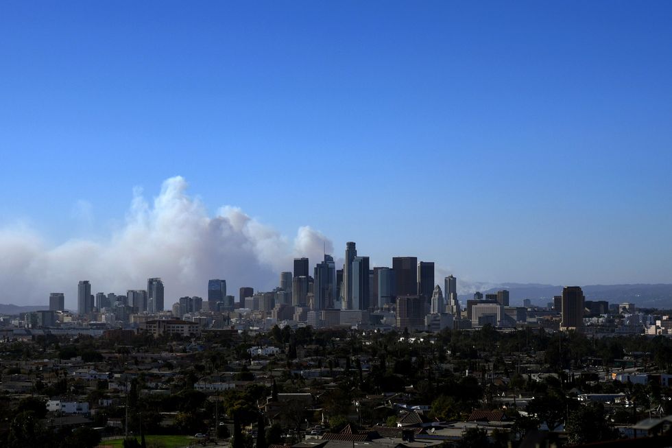 Smoke from the Palisades Fire billow over the Los Angeles skyline Tuesday.