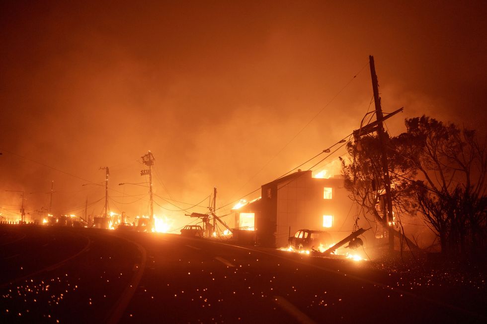 Houses burn in the Pacific Palisades neighborhood Tuesday night.
