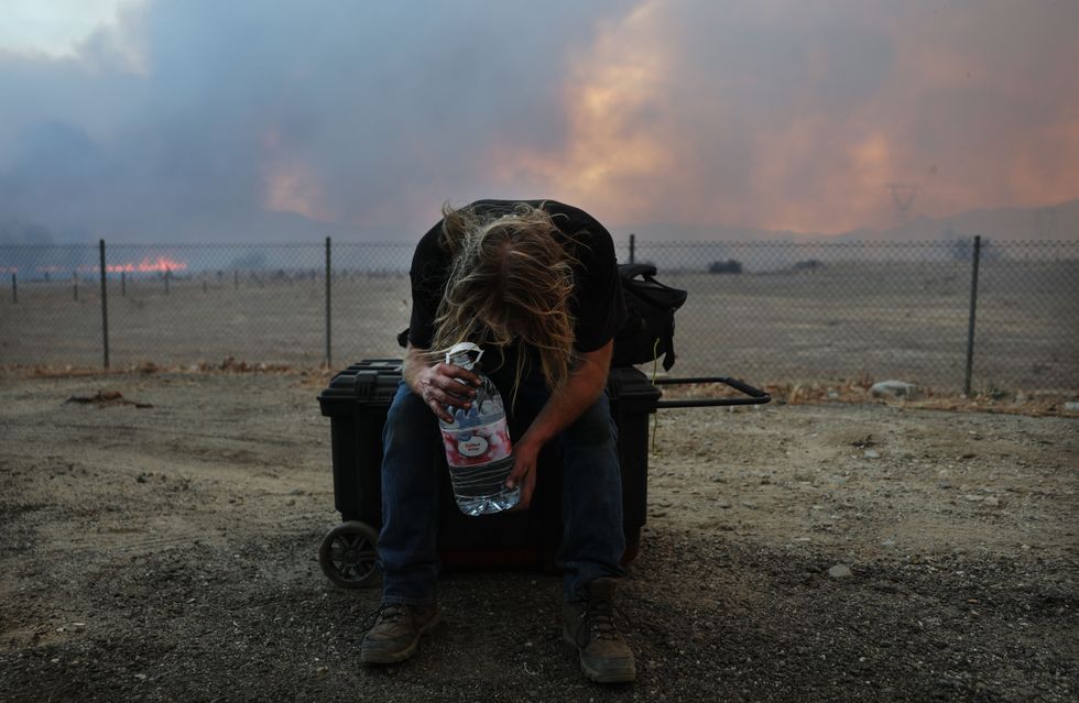 Resting after evacuating near Castaic, California.