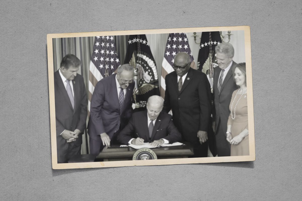 Joe Biden signing the IRA into law.