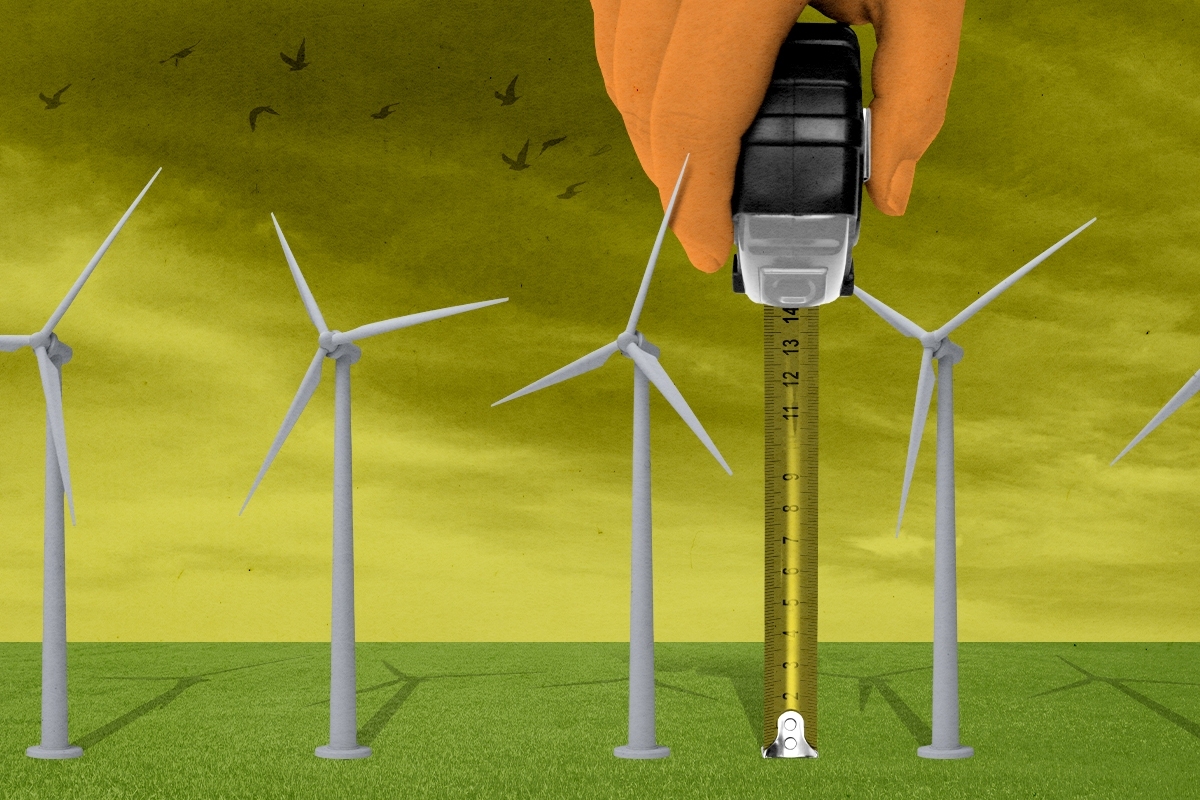 Trump measuring wind turbines.