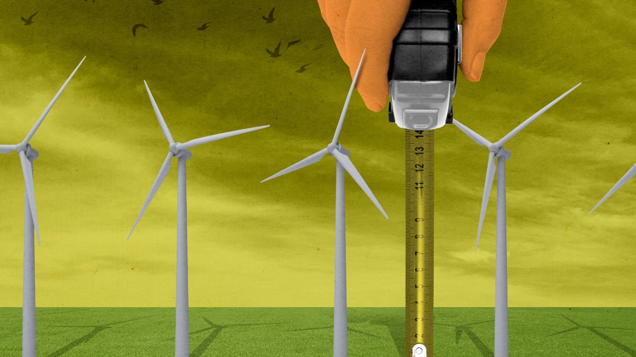 Trump measuring wind turbines.