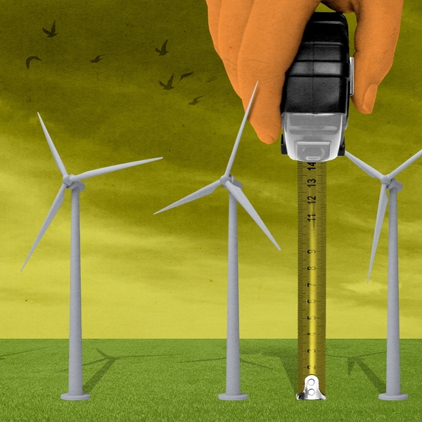 Trump measuring wind turbines.