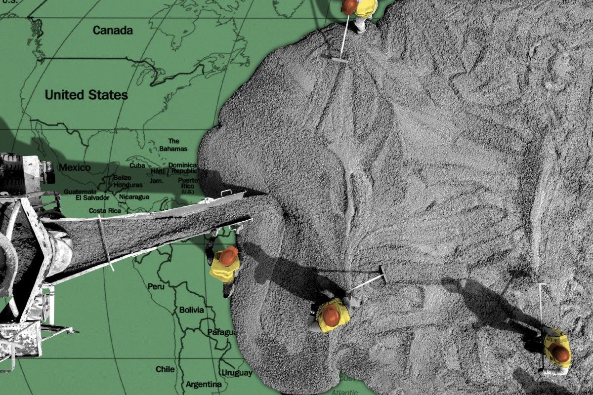 Workers pouring concrete on a world map.