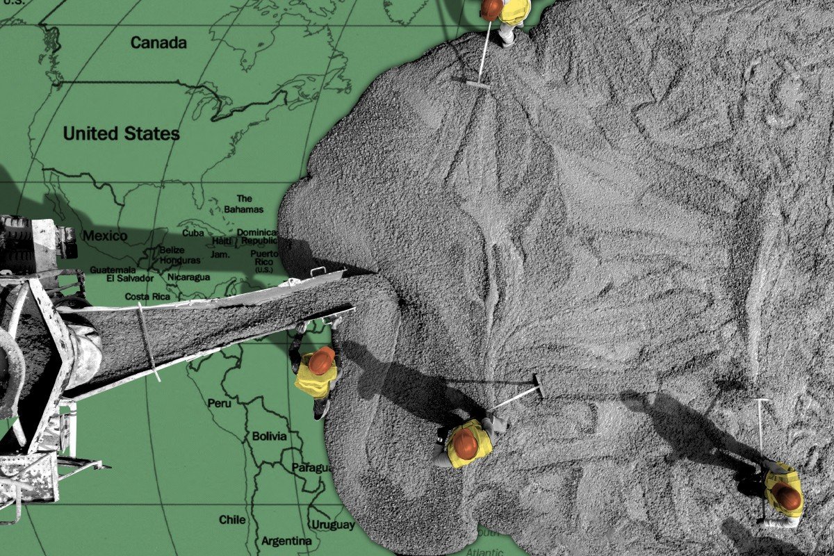 Workers pouring concrete on a world map.