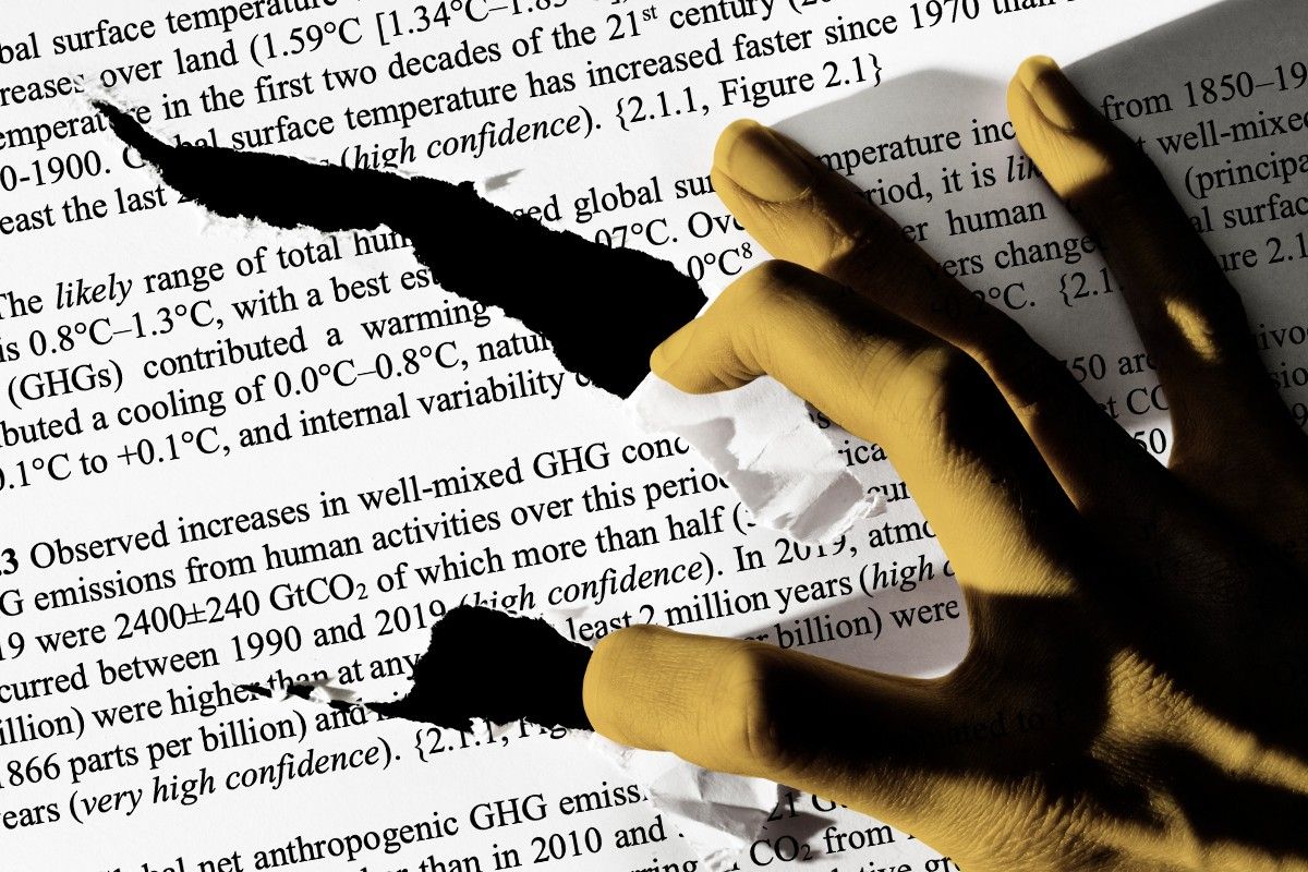 A hand tearing the IPCC report.