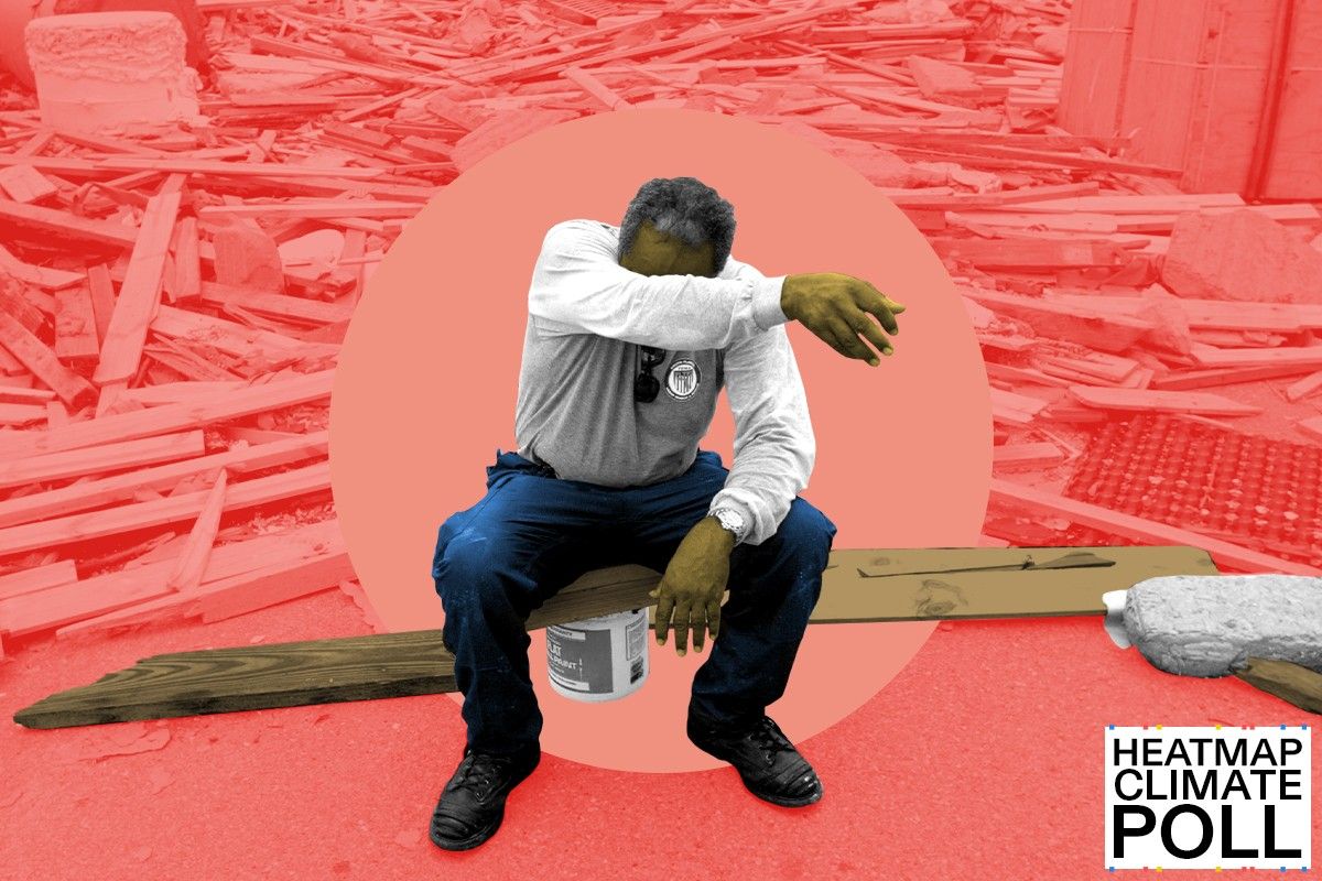 A man wipes his eyes amidst hurricane debris.