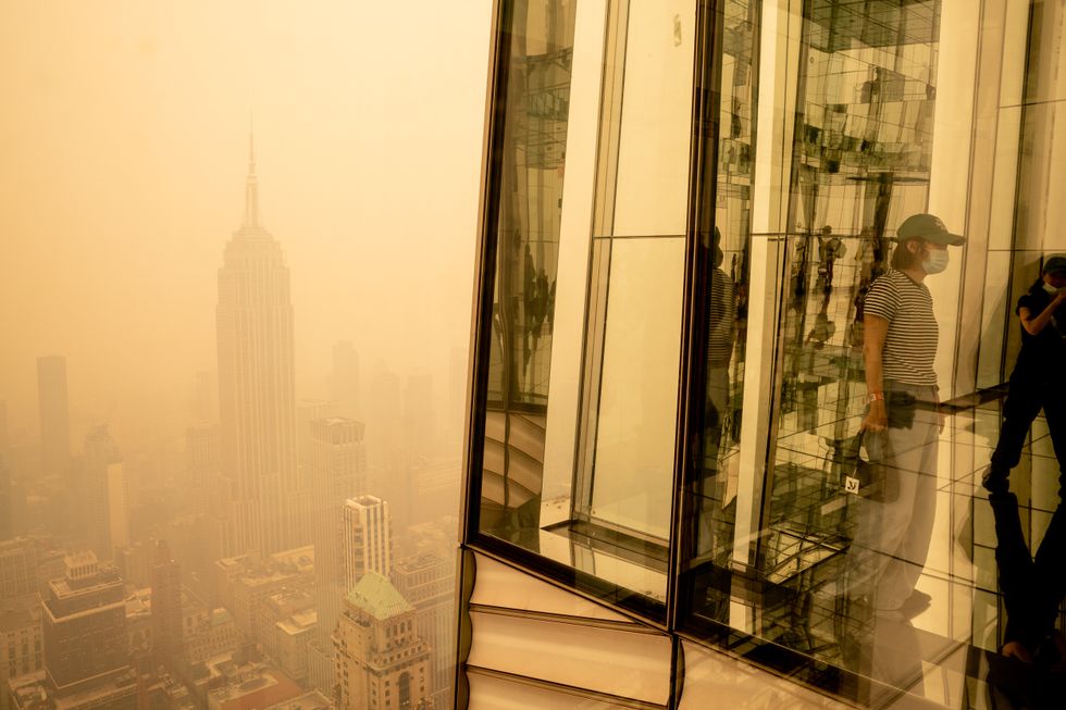 Visitors at Summit One Vanderbilt look out at Manhattan.