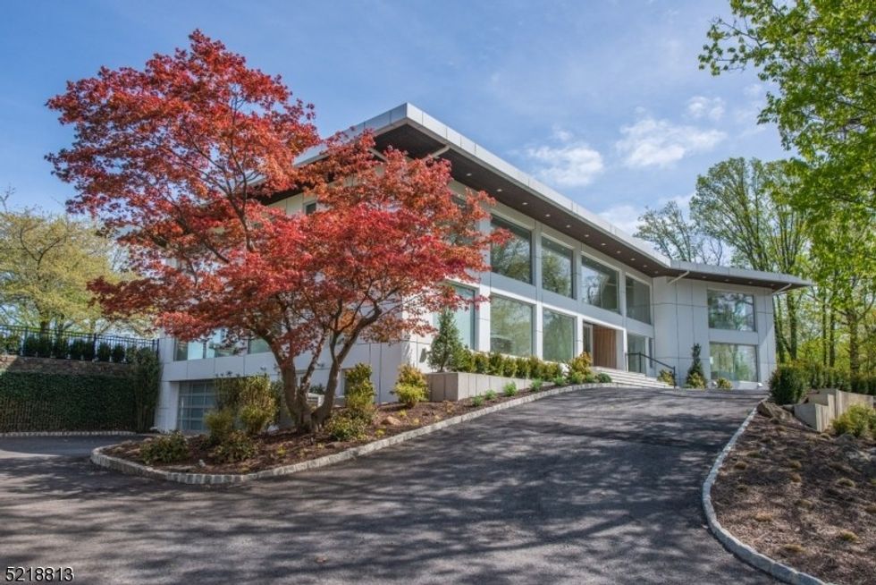 Aaron Rodgers' home in Montclair, New Jersey \u2014\u00a0a white, modern two-story home with windows across the front.