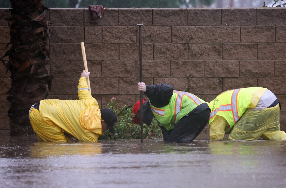 Workers attempting to unclog a drain.