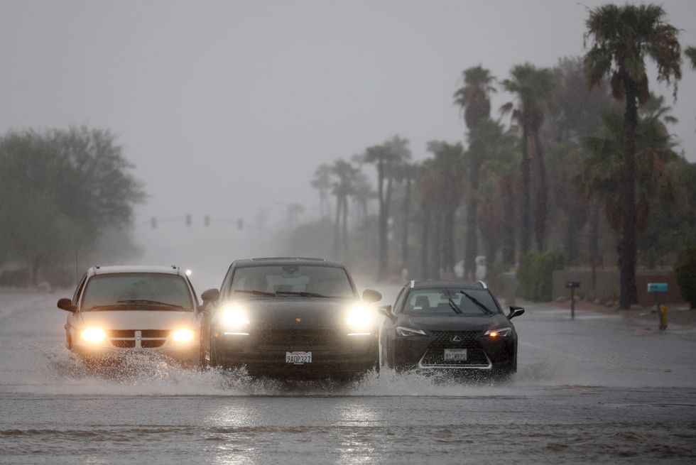 Cars on a flooded street.