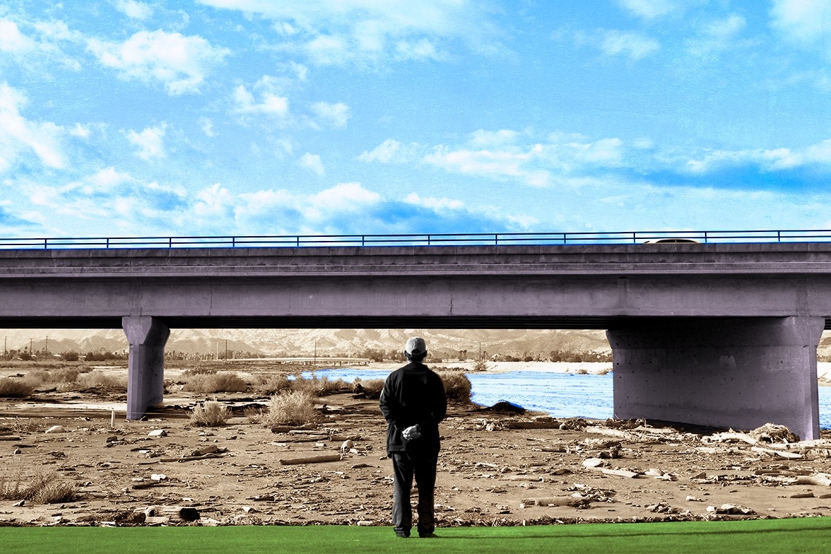A man inspecting Hilary storm damage.
