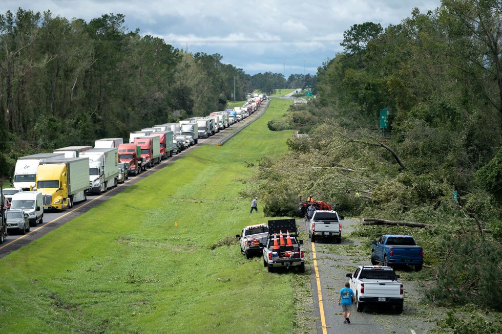 People working to clear Interstate 10 of fallen trees.